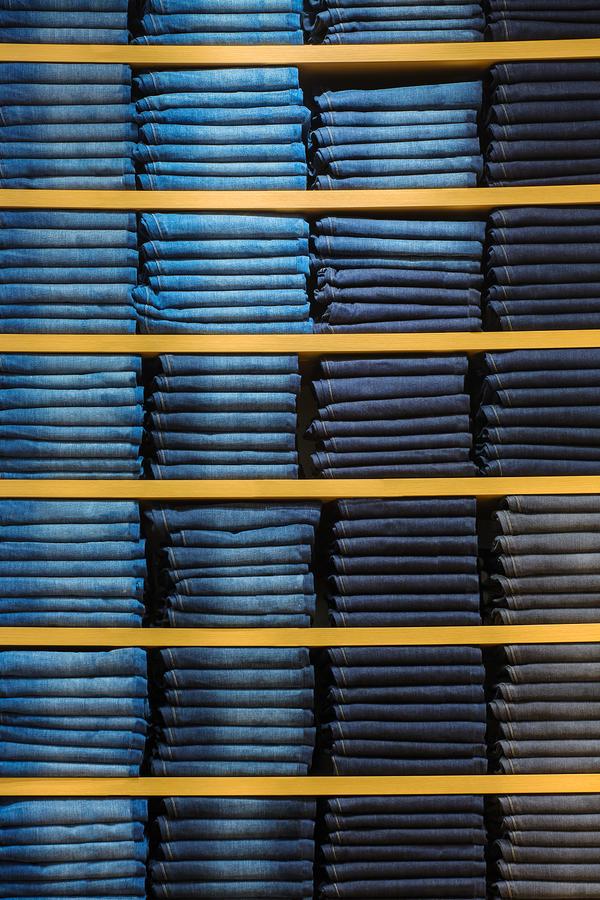 Neat stacks of folded jeans on the shop shelves Denim Hacker